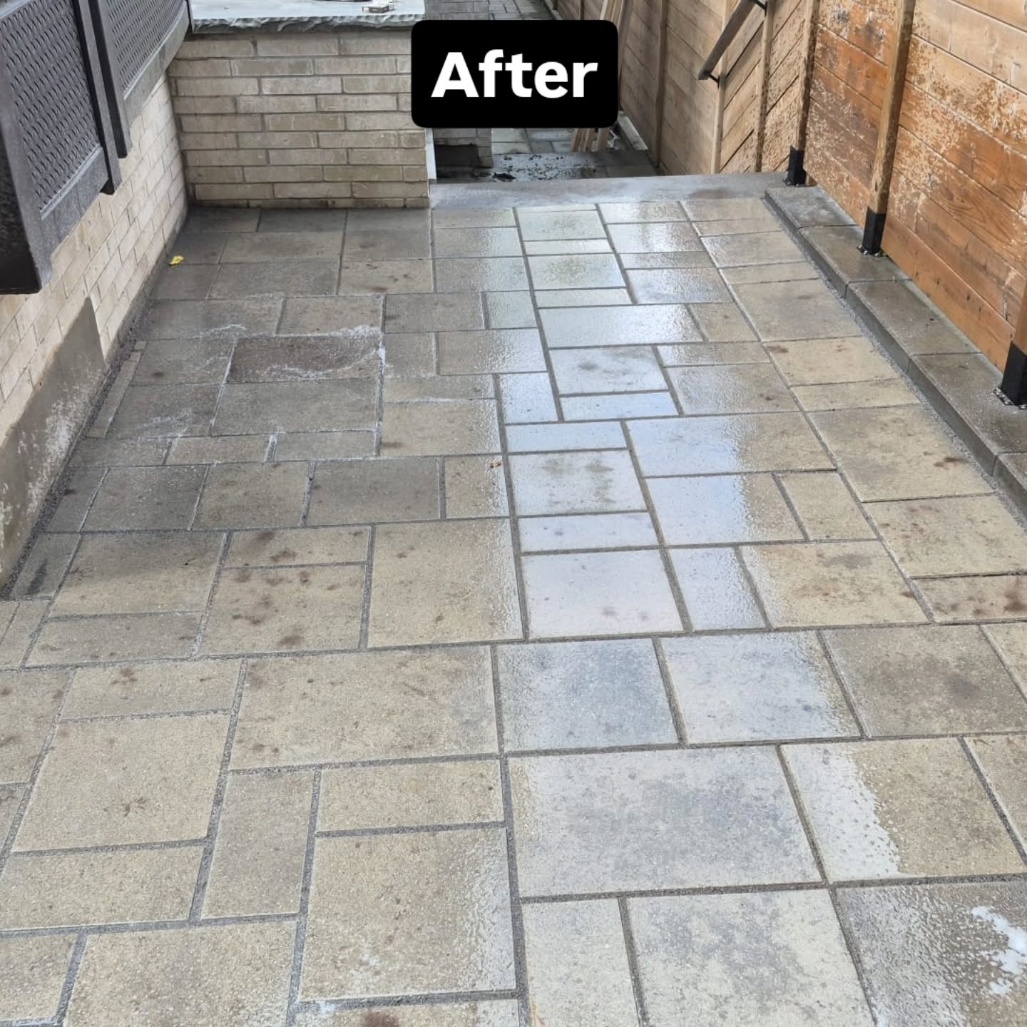 The relaid side walkway after completion, with clean joints and an even, tight paver pattern